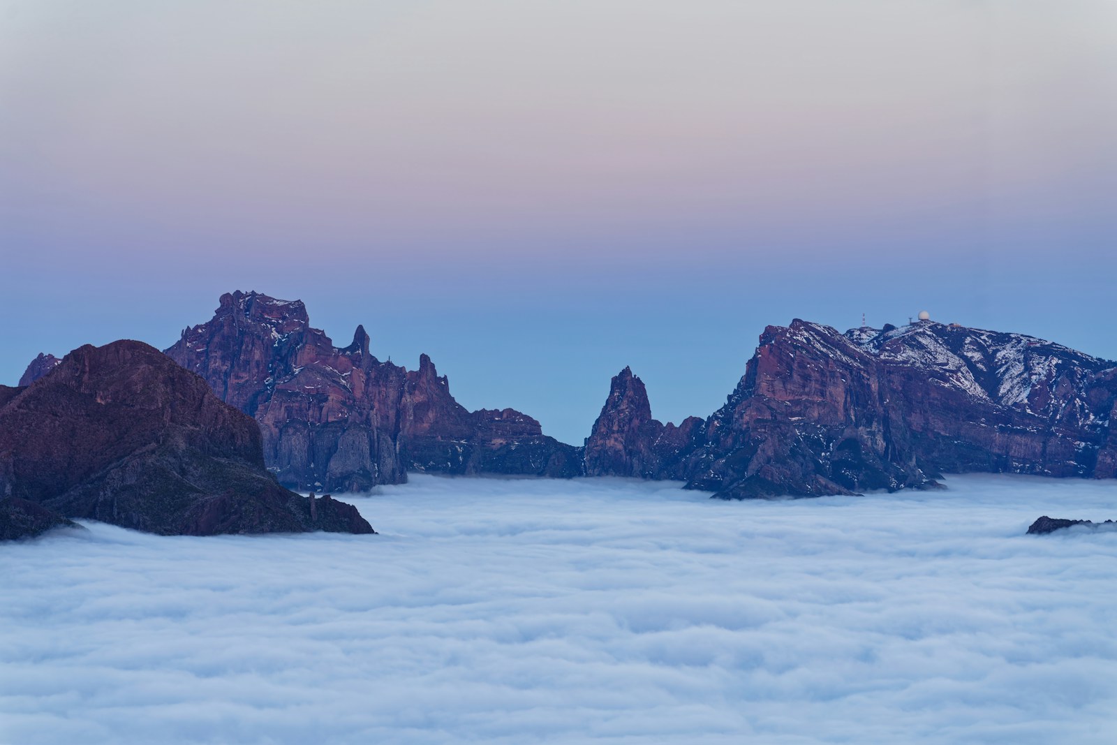 Mountain peaks emerging above clouds in Madeira